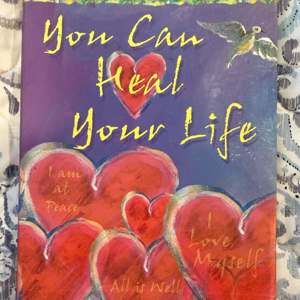 Inspirational books by Louise L. Hay and Caroline Myss, PH.D